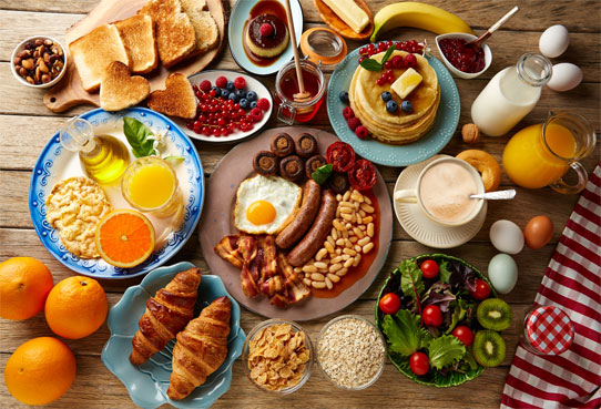 http://breakfast%20food%20such%20ass%20eggs,%20bacon,%20orange%20juice,%20pancakes,%20and%20cereal%20on%20a%20wooden%20table